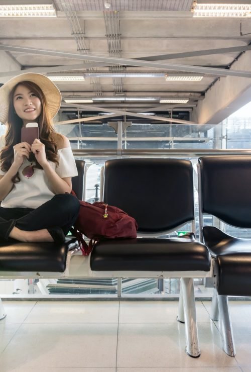 happy-asian-woman-traveler-holding-the-passport-with-suitcases-in-modern-an-airport-.jpg