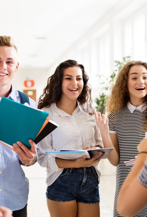 teenage-students-walking-in-high-school-hall-talking-.jpg